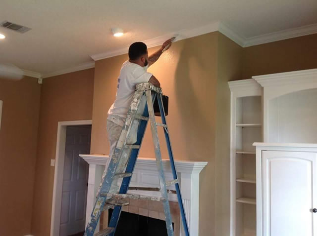 One of our crew members painting the inside of a house.